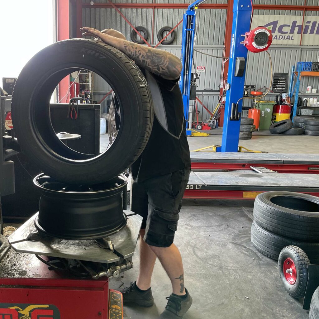 Staff member inspecting tyre at the Branigans Southport branch.