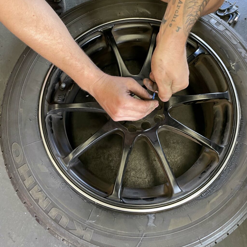 Repairing a wheel at Branigans Southport tyre shop in the Gold Coast.