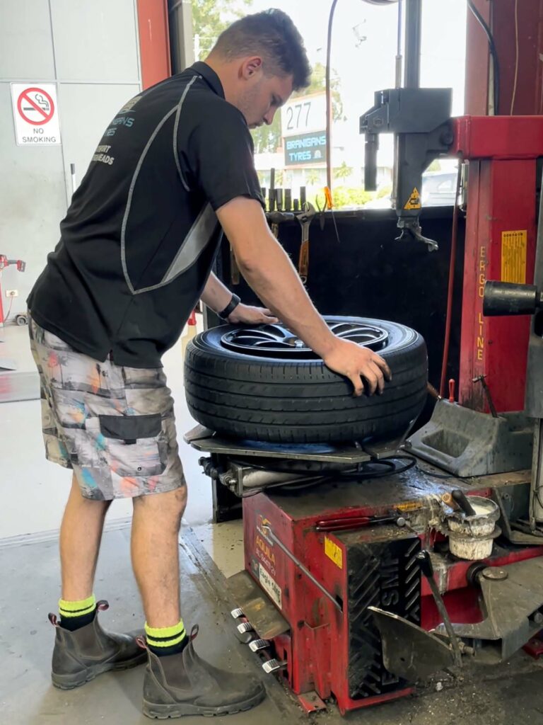 Fitting a new tyre at the Branigans Southport tyre shop in the Gold Coast.